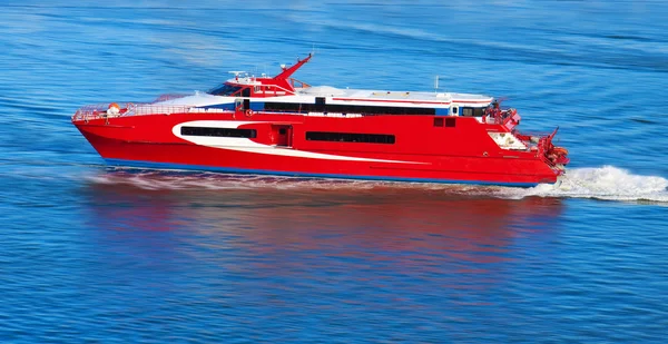 Red yacht with motion blur
