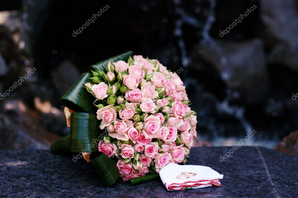 Wedding bouquet of pink roses with rings