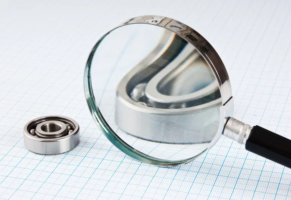 Magnifying glass and bearing — Stock Photo #4069928