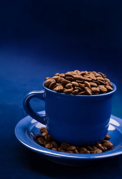 Coffee cup with grains on a dark blue background