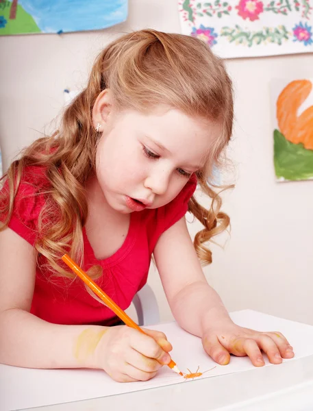 Child with colour pencil draw in preschool.