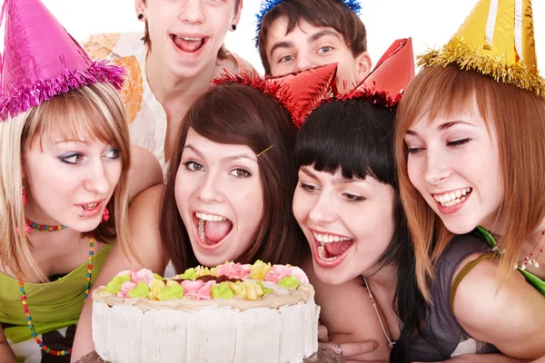 Group in party hat eat cake.