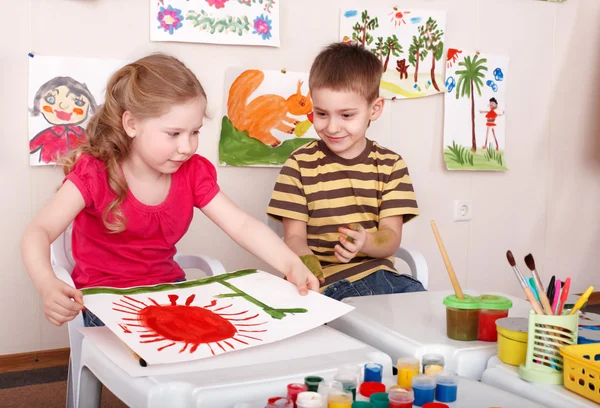 Children painting in play room.