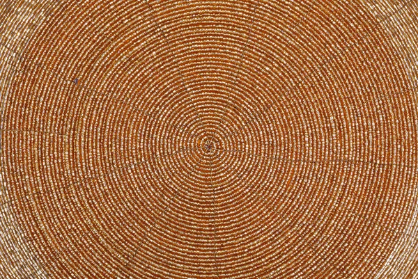 Golden beadwork texture background with round lines pattern