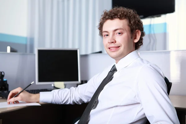 A young businessman in office