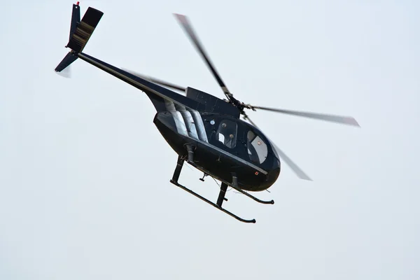 Black helicopter in flight