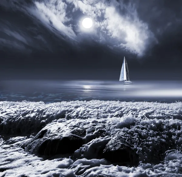 Moon in clouds sky above the sea with yacht