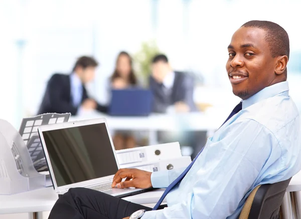 portrait of a happy african american entrepreneur displaying computer lapto