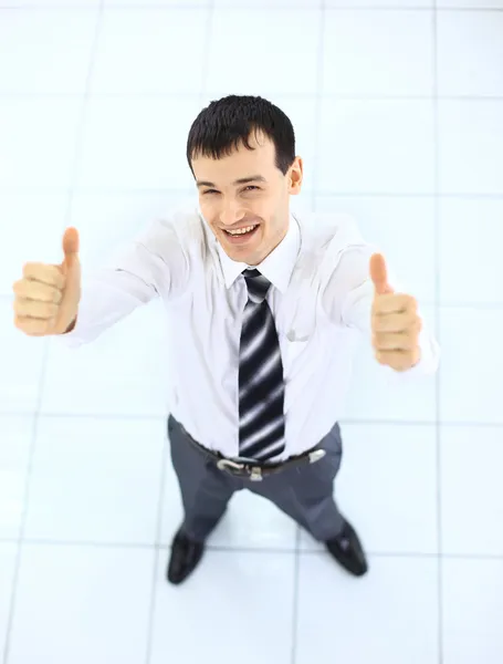 Happy businessman standing outside with arms outstretched