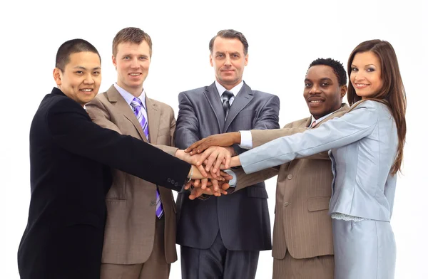 A diverse group of business workers with their hands together in form of te