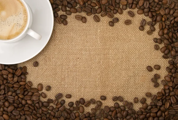 Coffee beans as a frame, and a cup of coffee