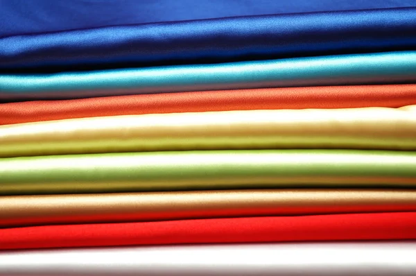 stack-of-satin-fabric-of-various-colours-stock-photo-elnur-4427540