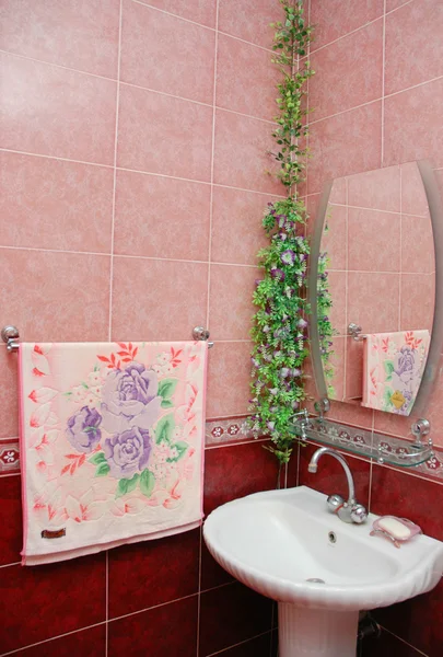Sink in the bathroom with pink tiles