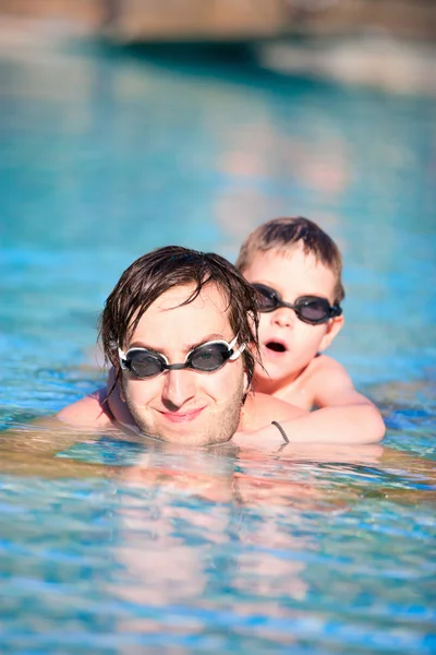 Father and son in swimming pool