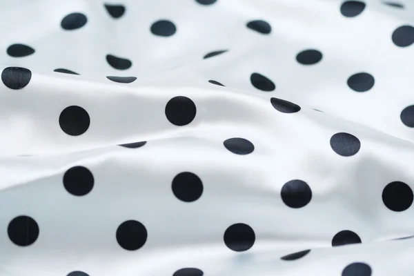 Black polka dots on a white background
