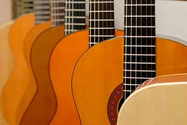 Row of classical acoustic guitars in musical store. Close-up vie