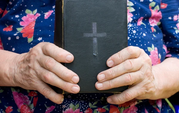 The old woman reads the bible