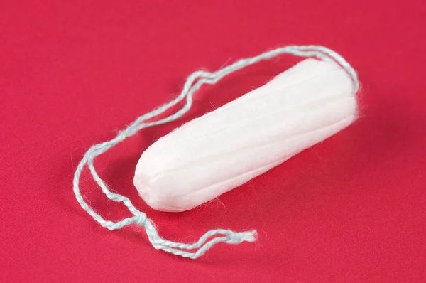 Ladies feminine hygiene product on a red background