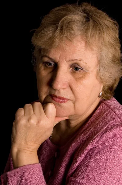 The elderly woman on black background