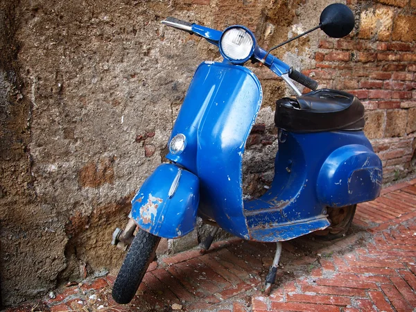Vintage scooter in front of a brick wall
