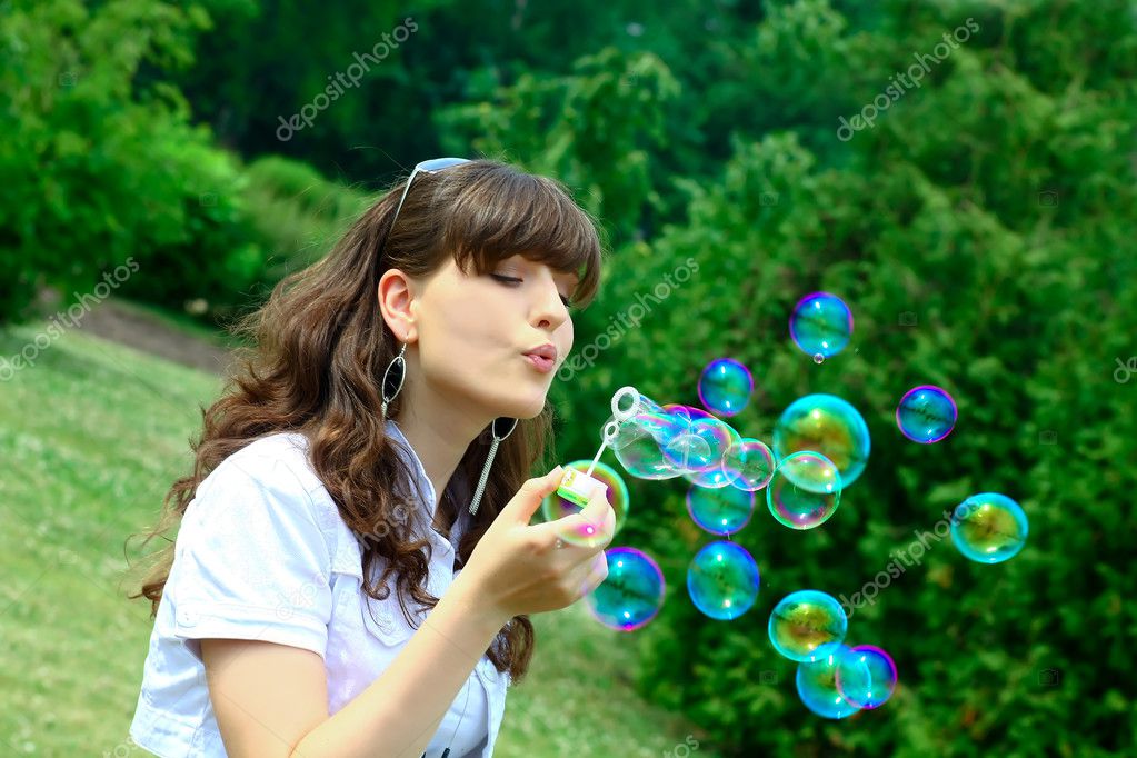 blowing soap bubbles