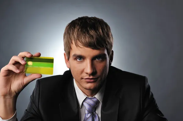 Handsome man holding credit card