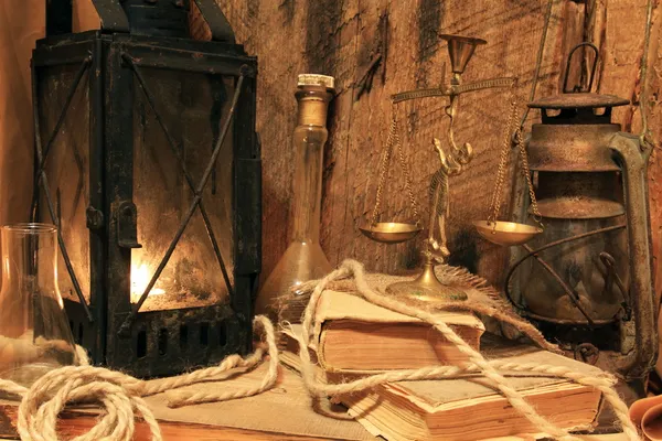 Still life - old lamps, books and balance