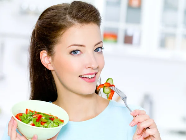 Happy woman eat vegetable salad