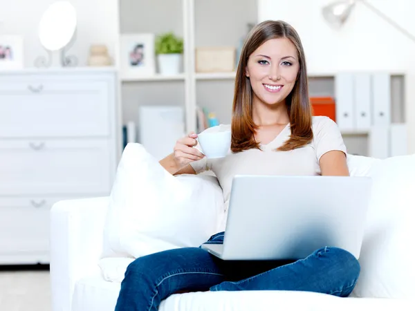 Woman with laptop and cup of coffee