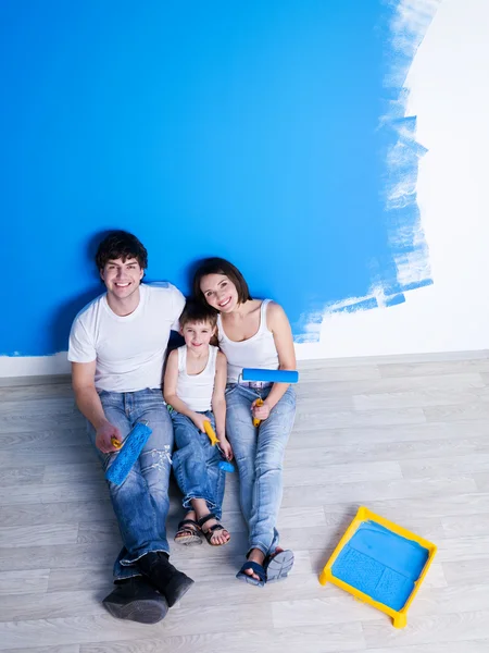 Painting the wall by happy family