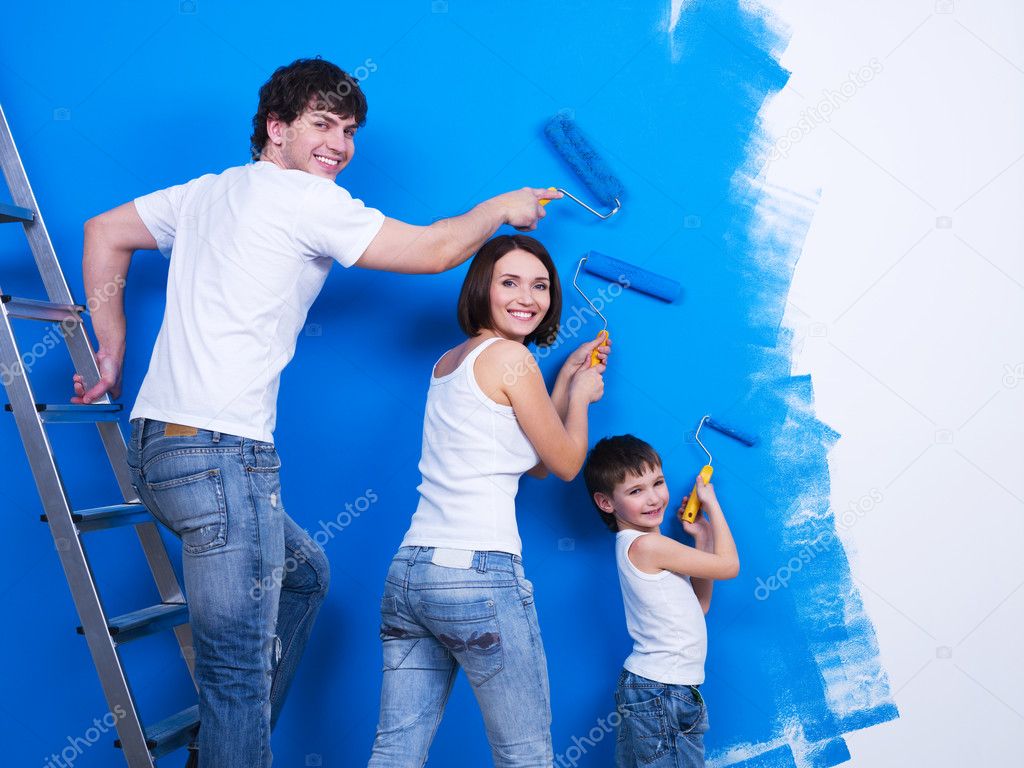 Young family painting the wall — Stock Photo © valuavitaly #4101007