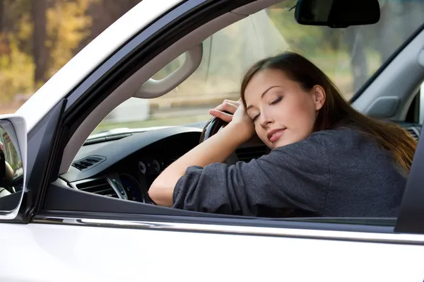 Young woman sleeps in the car