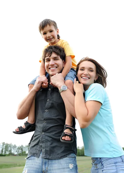 Happy beautiful young family posing outdoors