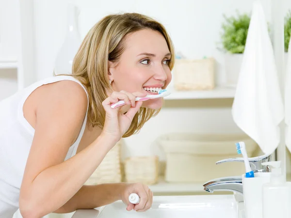 Woman cleaning teeth with toothbrush