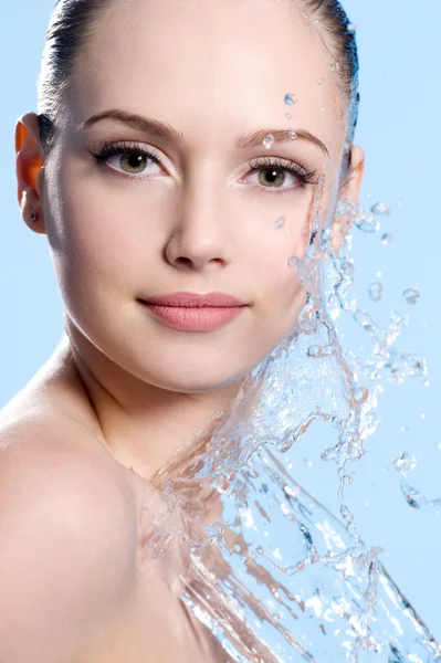 Young Female face with splash of water