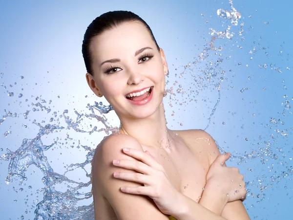 Happy woman in splashes of water