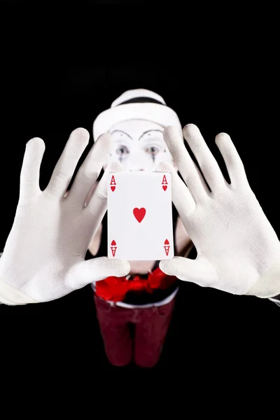 Funny mime holding a ace of hearts