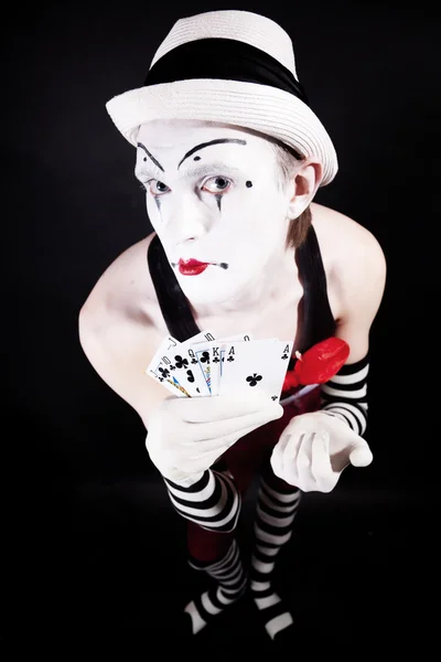 Circus clown with playing cards