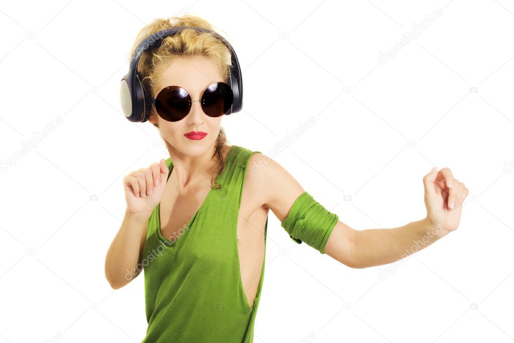 Young woman wearing sunglasses and wireless headphones isolated on white 