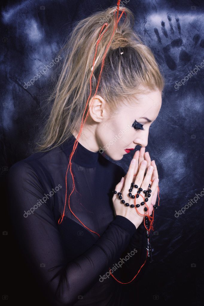 goth style makeup. Praying woman with make-up in Gothic style