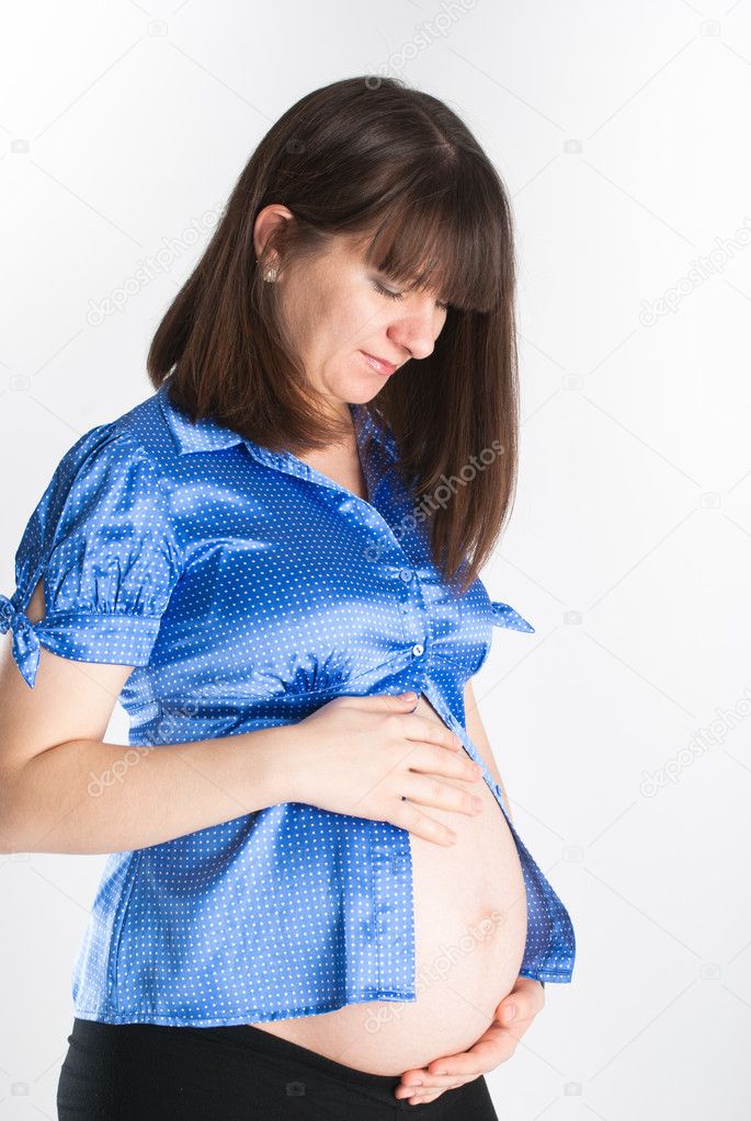 Portrait of the pregnant beautiful girl with a naked stomach
