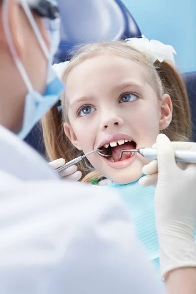 Child examines the dentist in the clinic