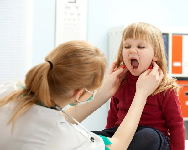 Doctor pediatrician examining baby mouth