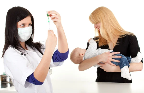 Female doctor examining baby boy