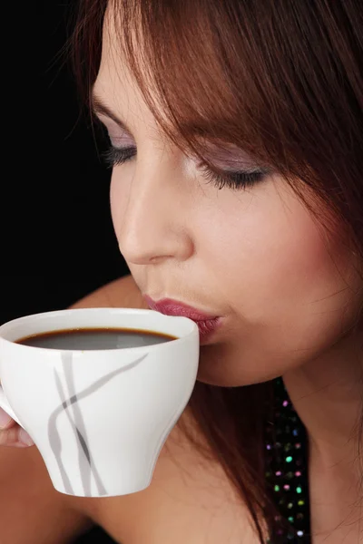 Elegant young woman drinking coffee