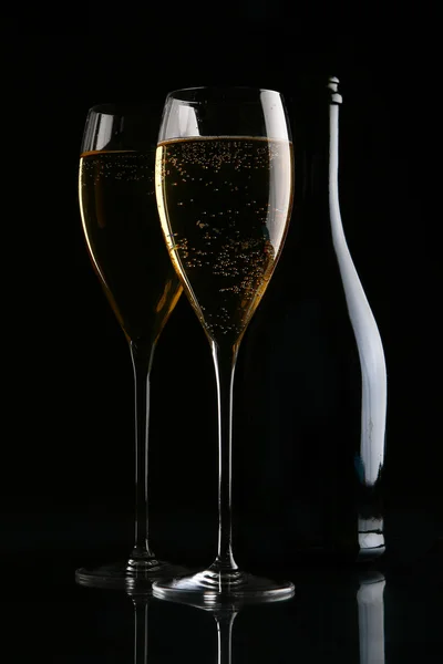 Two elegant glasses with gold champagne