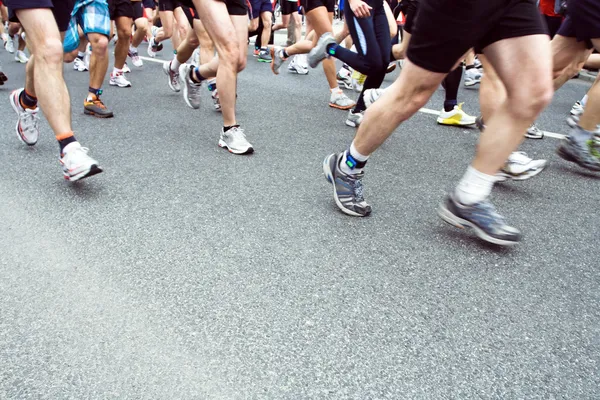 Running in city marathon on street, motion blur