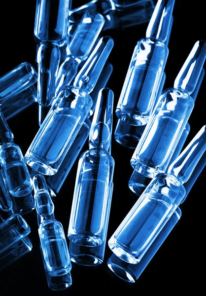 Medical ampoules on black background