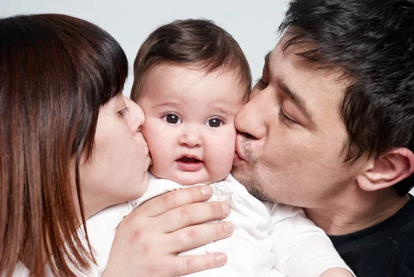 Baby with parents on a white background