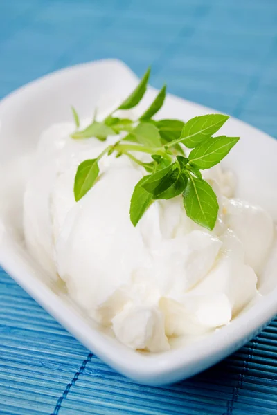 Sour cream with basil leaves